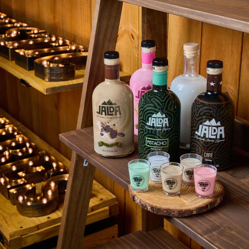 a bottle of wine sitting on top of a wooden table