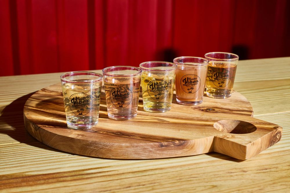 a glass of wine sitting on top of a wooden table